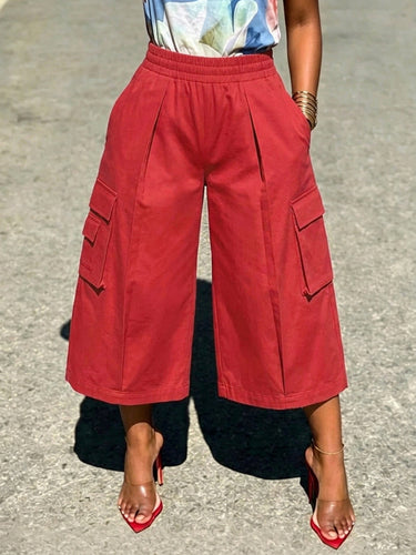 Pantalones de color liso con bolsillos sueltos y elásticos de talle alto